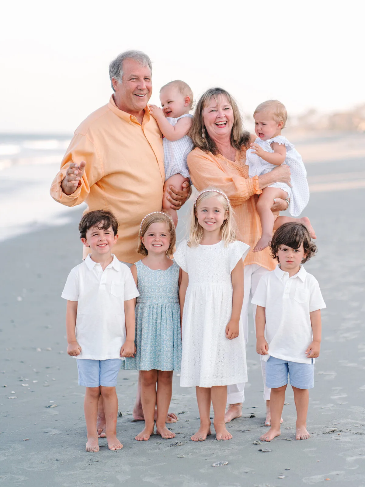 Grandparents and grandchildren in white on DeBordieu Beach