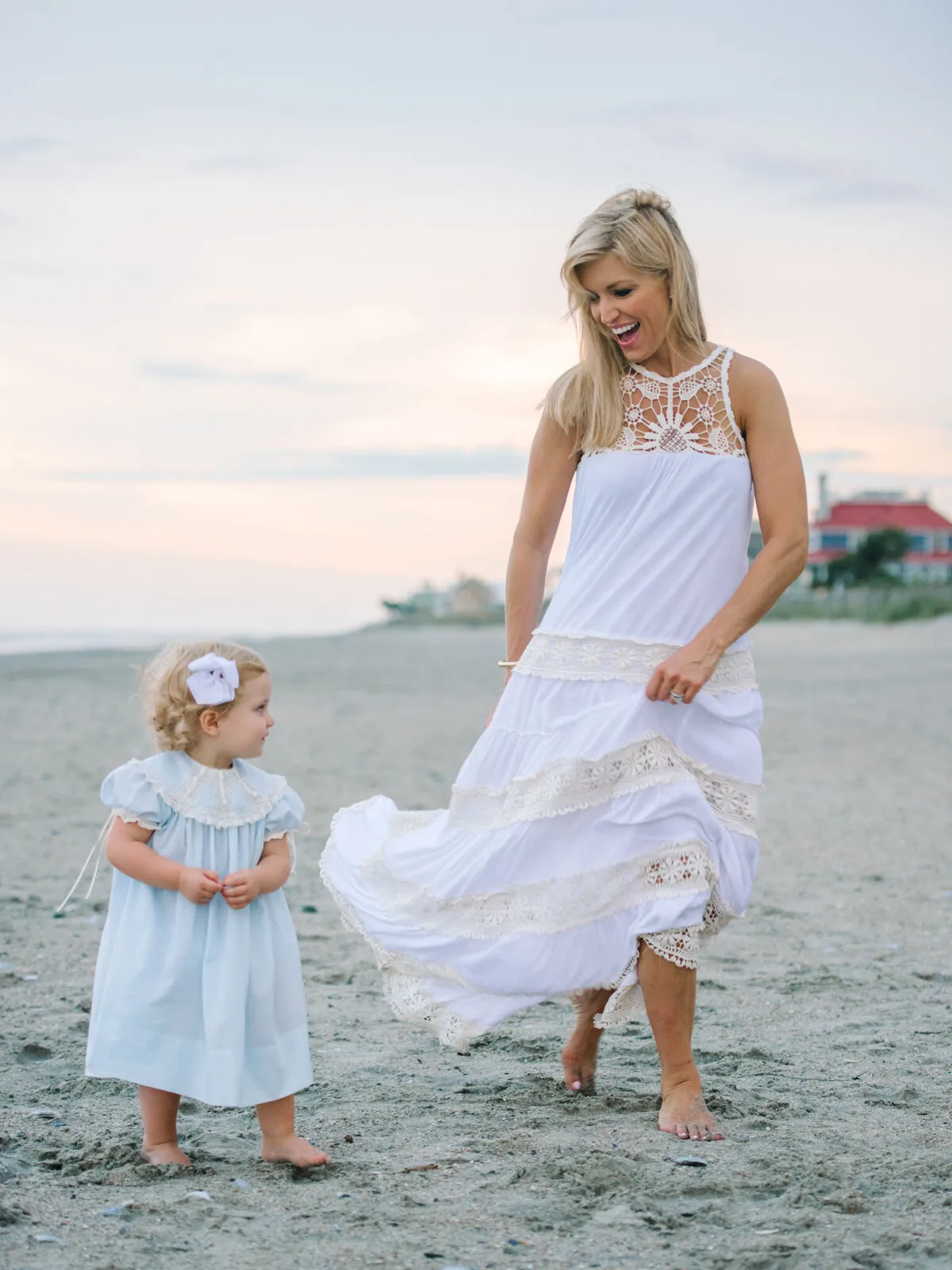 Mother and toddler walking at sunset on DeBordieu Beach