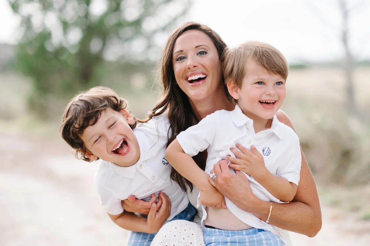 Mother laughing with her two sons at DeBordieu Beach