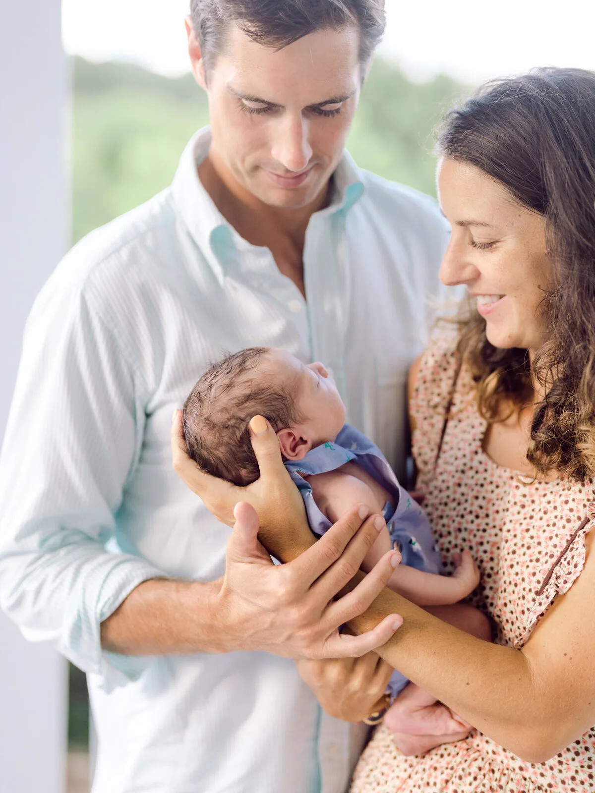 Parents holding their newborn baby at DeBordieu Beach in Georgetown SC