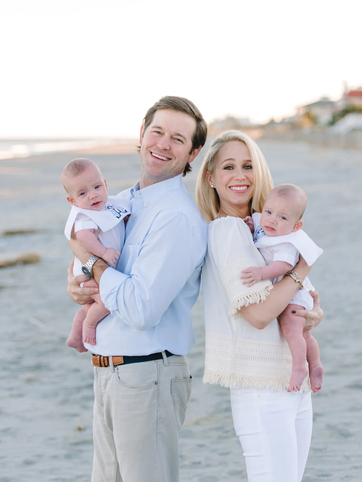 Parents holding their two babies on DeBordieu Beach in Georgetown SC