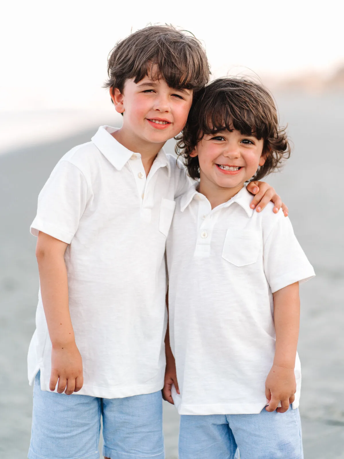 Two brothers in white shirts on DeBordieu Beach in Georgetown SC