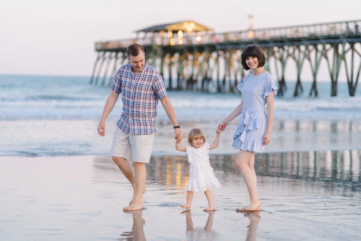 Family walking near the fishing pier in Garden City Beach SC