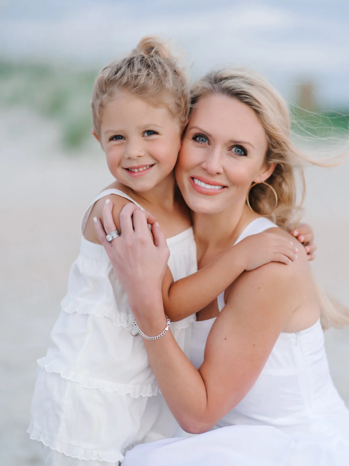 Mother and daughter hugging on the beach in Garden City Beach SC