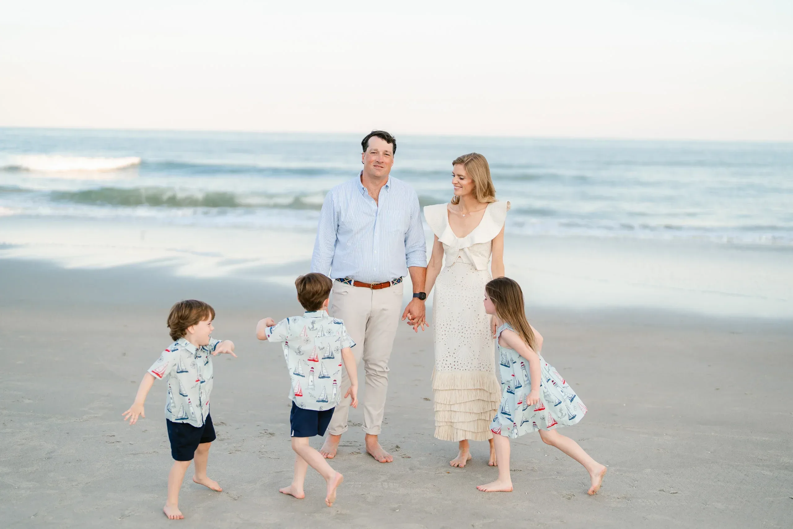 Family of five on the beach by the ocean by Pasha Belman Photography