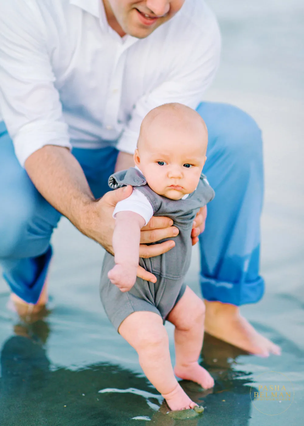 Dad holding his baby boy in the tidal water in North Myrtle Beach