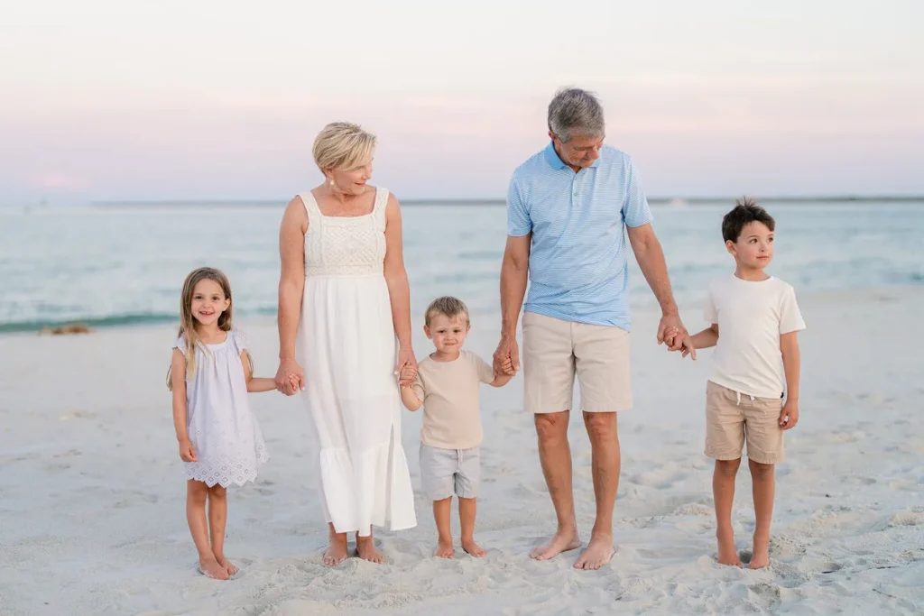 Family of five walking the beach at golden hour in North Myrtle Beach