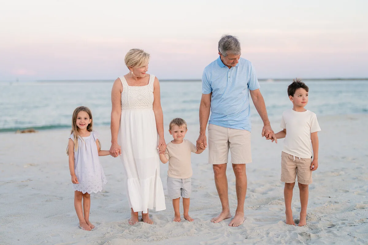 Family of five walking the beach at golden hour in North Myrtle Beach