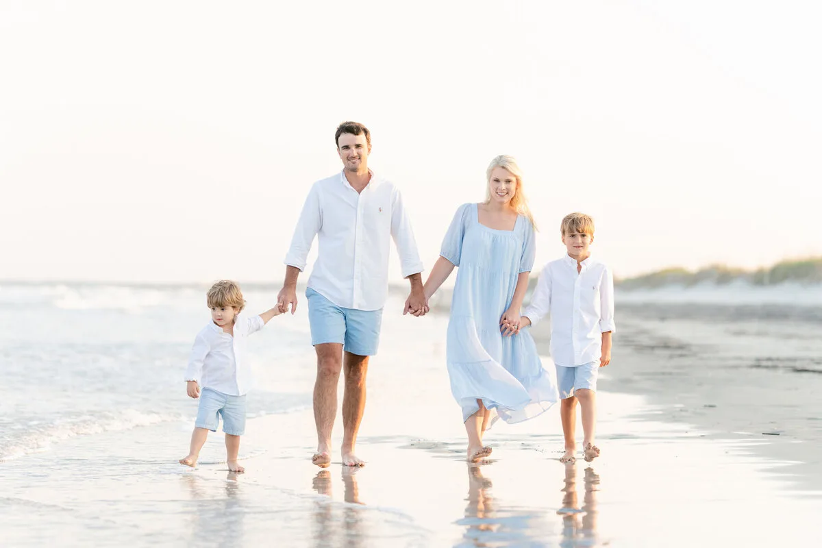 Family walking the beach at low tide at sunrise in North Myrtle Beach