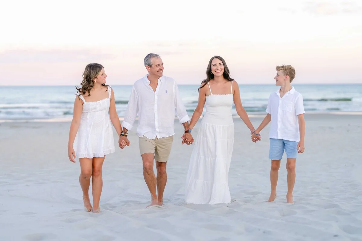 Family walking hand in hand at Huntington Beach State Park near North Myrtle Beach