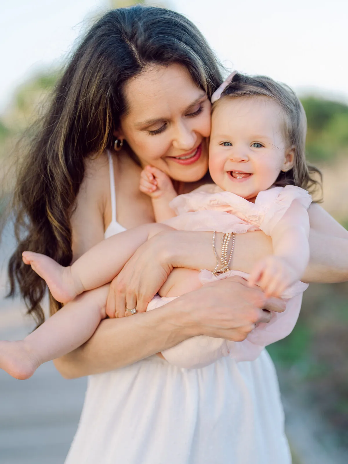 Mother holding her baby girl in a close-up portrait in North Myrtle Beach