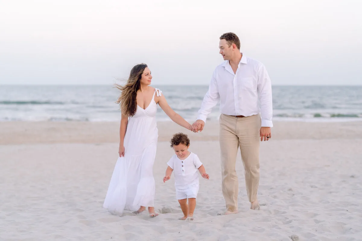 Parents and toddler walking the beach in North Myrtle Beach