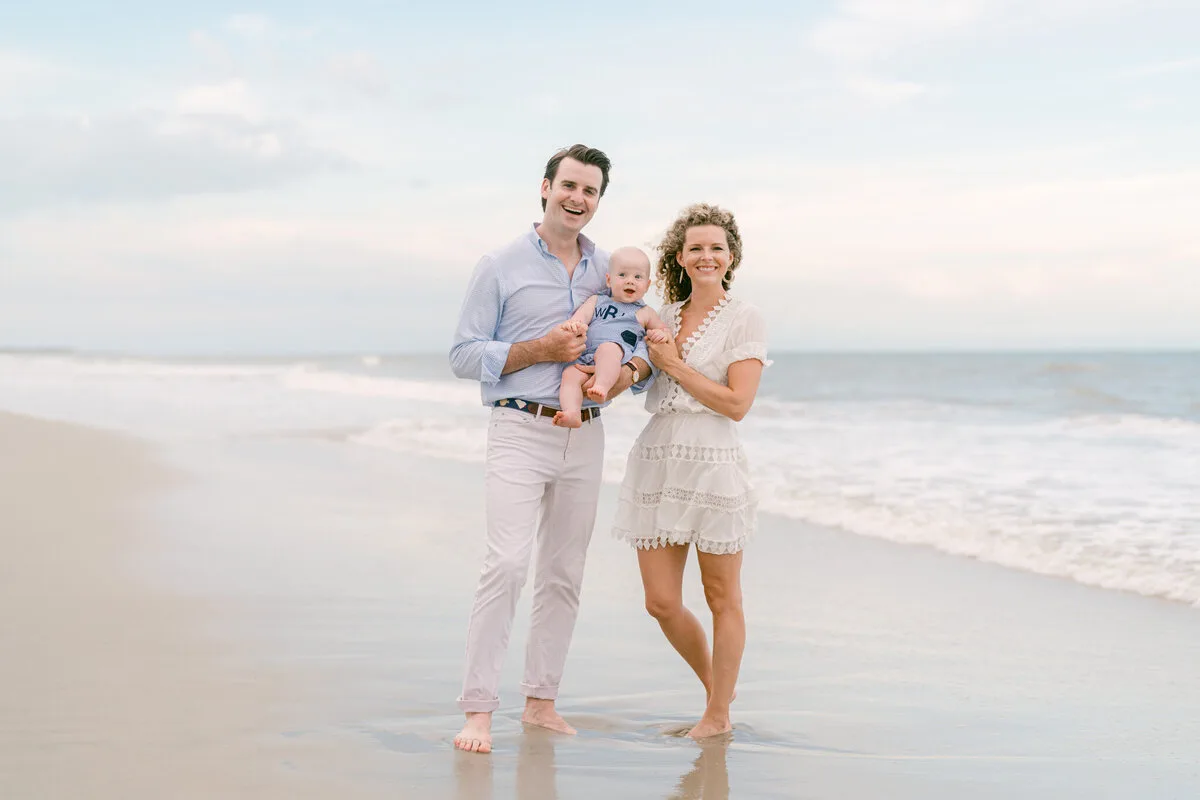 Parents holding their baby on the beach in North Myrtle Beach