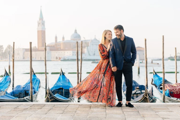 Pasha Belman and Natallia Belman by the gondolas in Venice, Italy