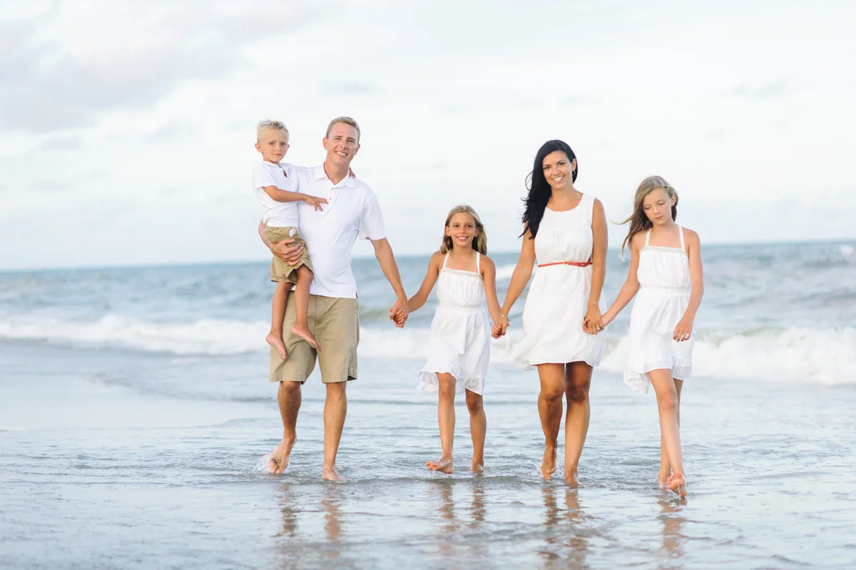 Family wading in the ocean together at Pawleys Island beach