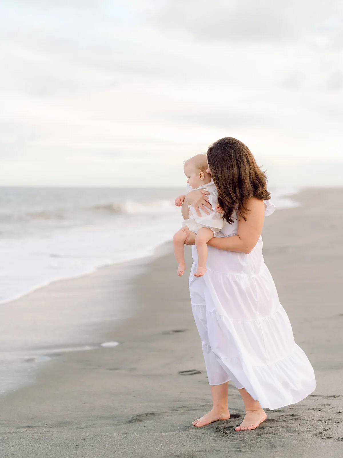 Mother and toddler at the water's edge on Pawleys Island beach
