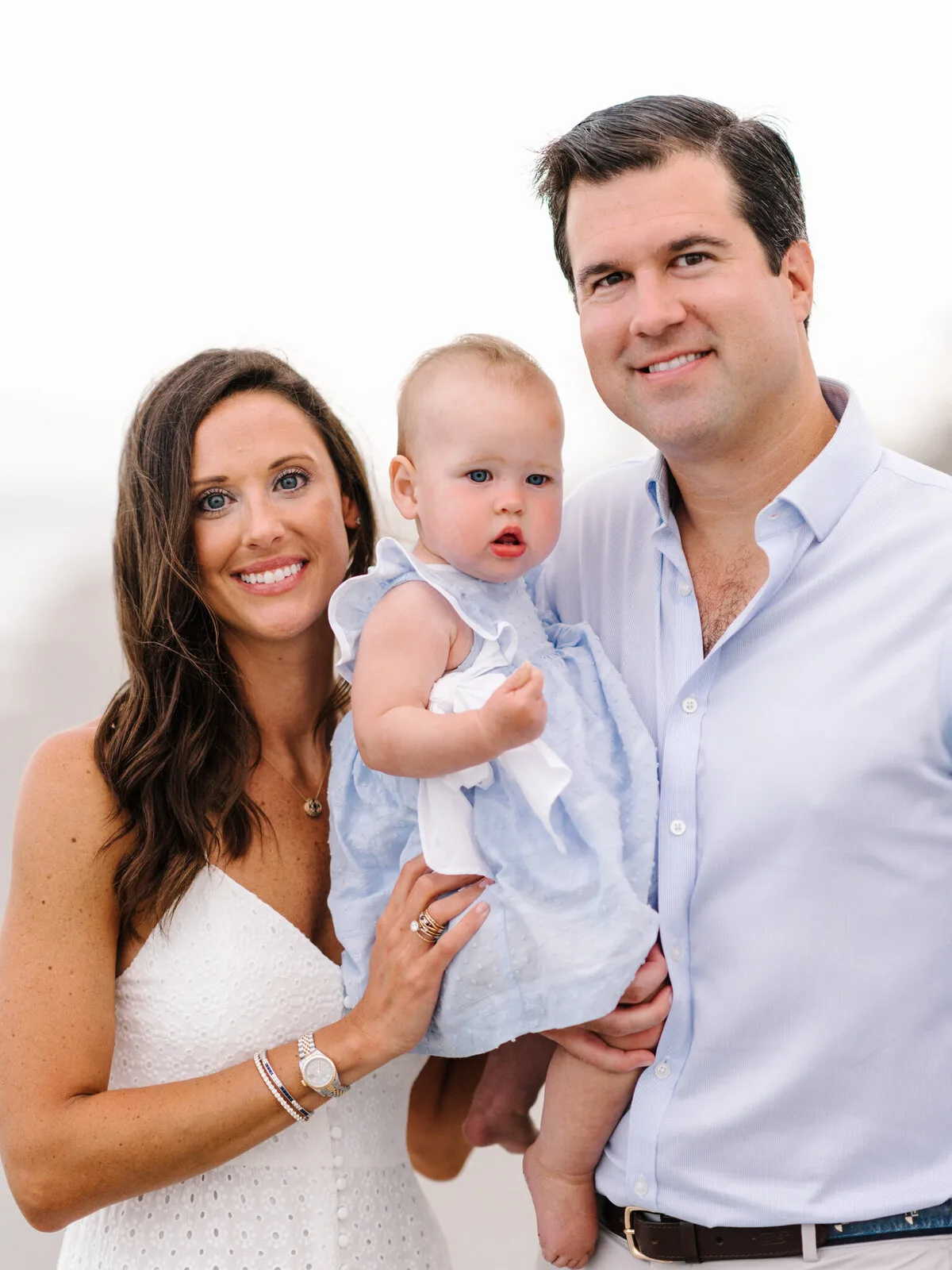 Parents holding their baby boy during a family beach session in Pawleys Island